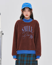 Pull en matière Pilou Pilou de couleur rouge marron et bleu