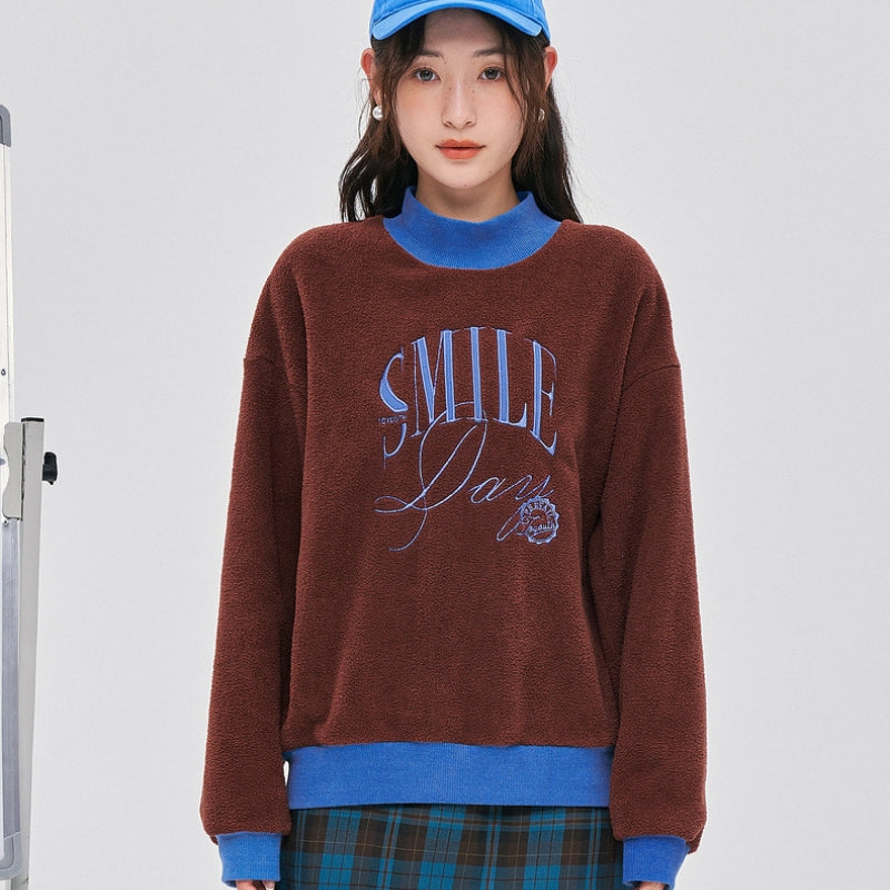 Pull en matière Pilou Pilou de couleur rouge marron et bleu
